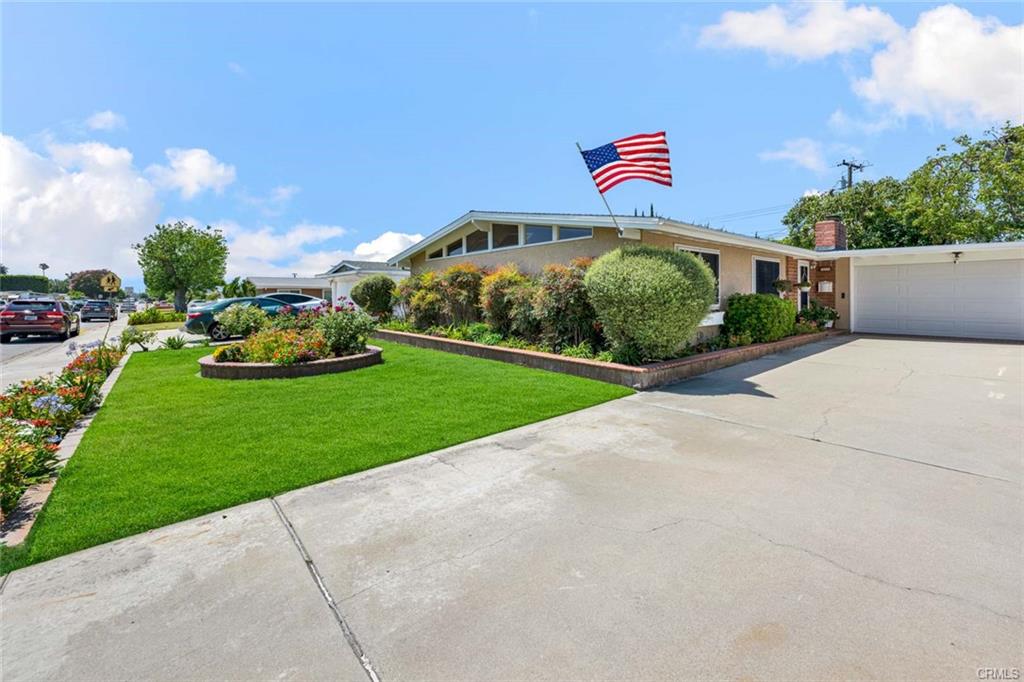 Wide, tree-lined Garden Grove street with mid-century homes