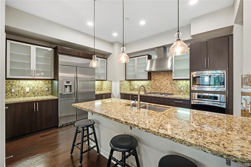 21 Gramercy #202 — gourmet kitchen with granite island, European cabinetry, and bar seating