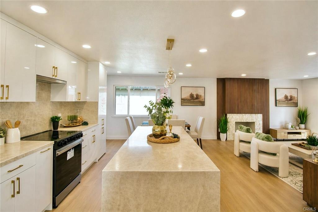 9142 Parliament Ave — remodeled kitchen with waterfall island open to the family room