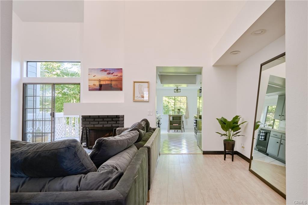 8132 Atwater Cir #202 — living room with fireplace and open flow to the dining area