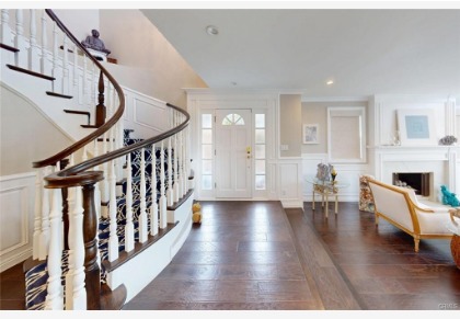 16143 Saint Croix — entry foyer with curved staircase and hardwood flooring