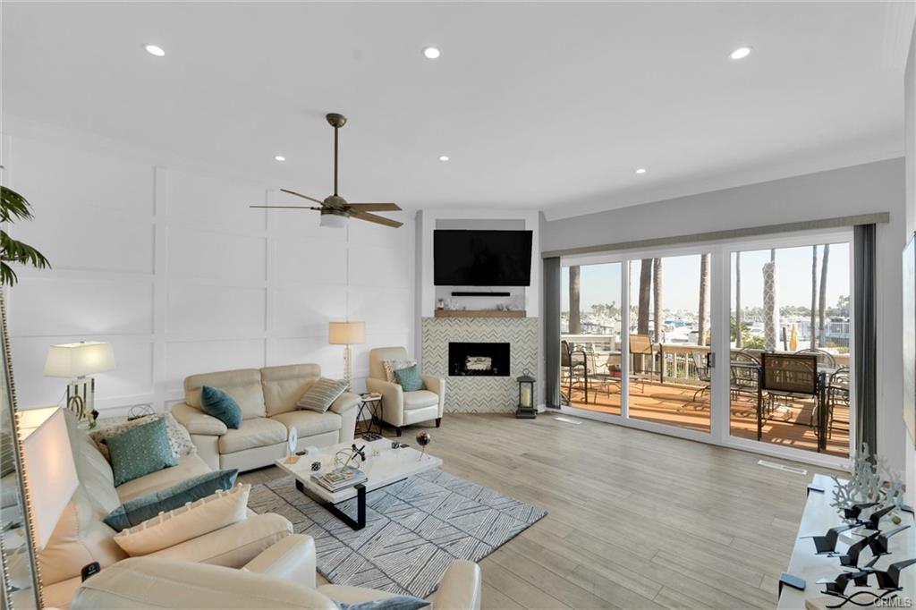 16276 Pacific Cir #B — open great room with coastal furnishings and wide-plank flooring