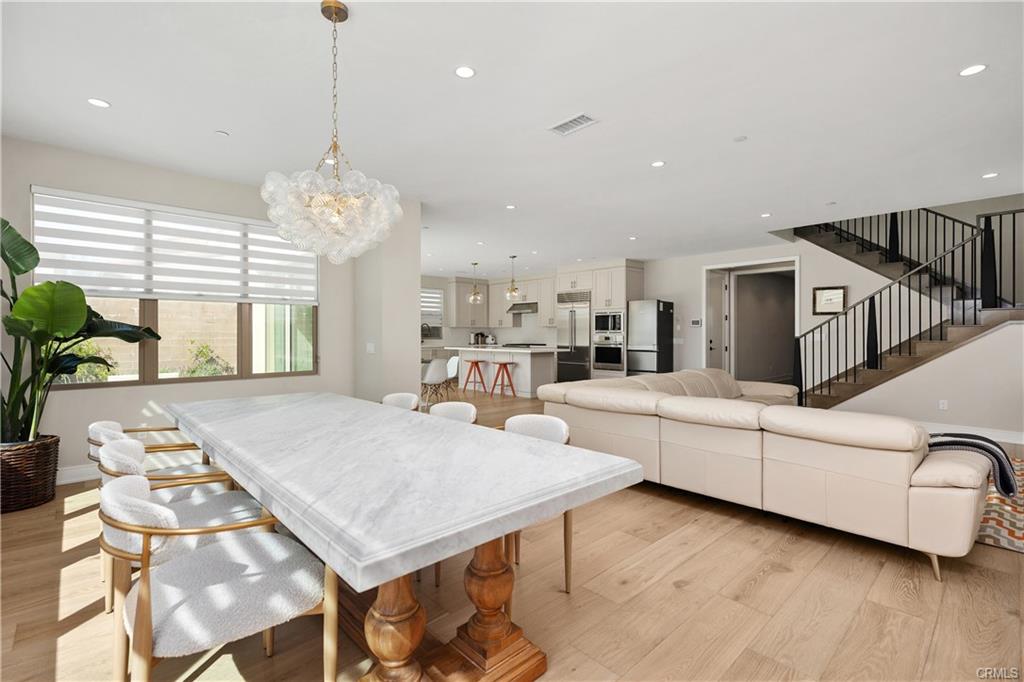 142 Sabbia — formal dining area with marble table and chandelier