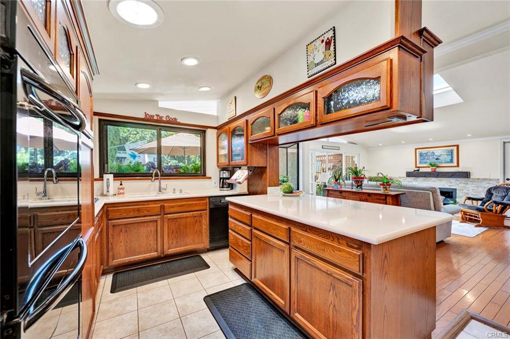 12231 Wilken Way — kitchen with quartz counters and custom wood cabinetry
