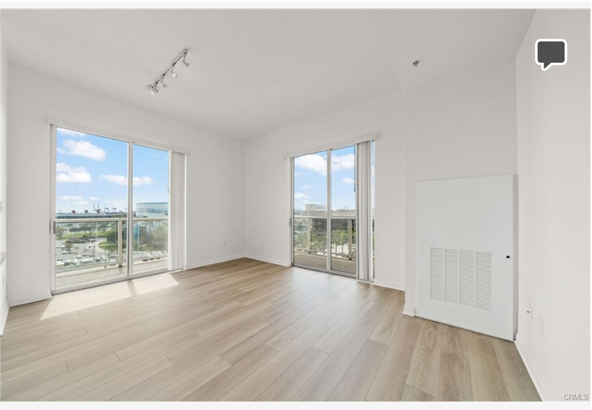 488 E Ocean Blvd #717 — living area with wide-plank flooring and natural light