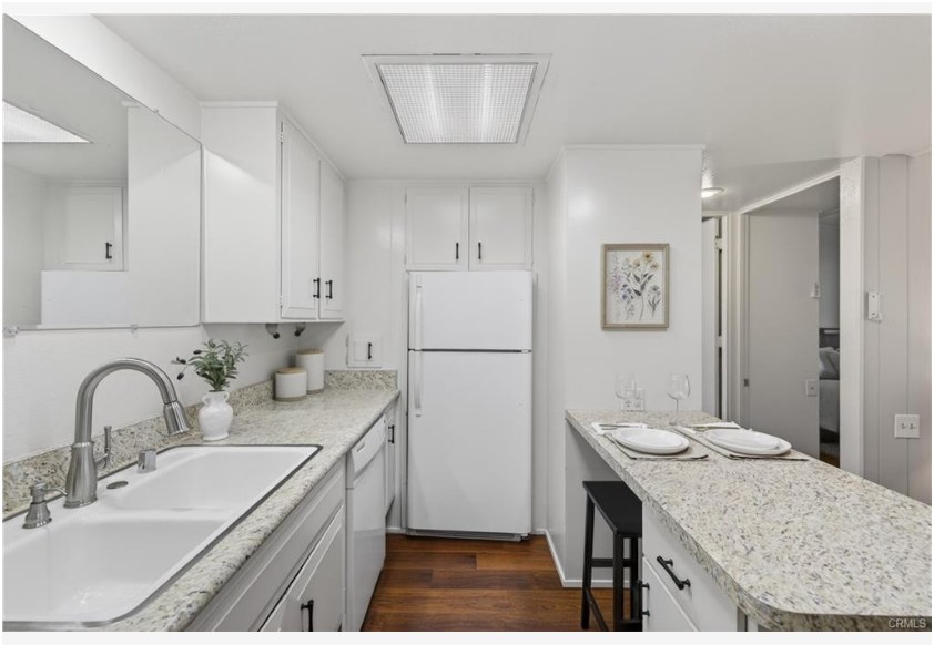 1200 Canoe Brook Dr #19D — kitchen with granite counters, newer white appliances, and refreshed hardware