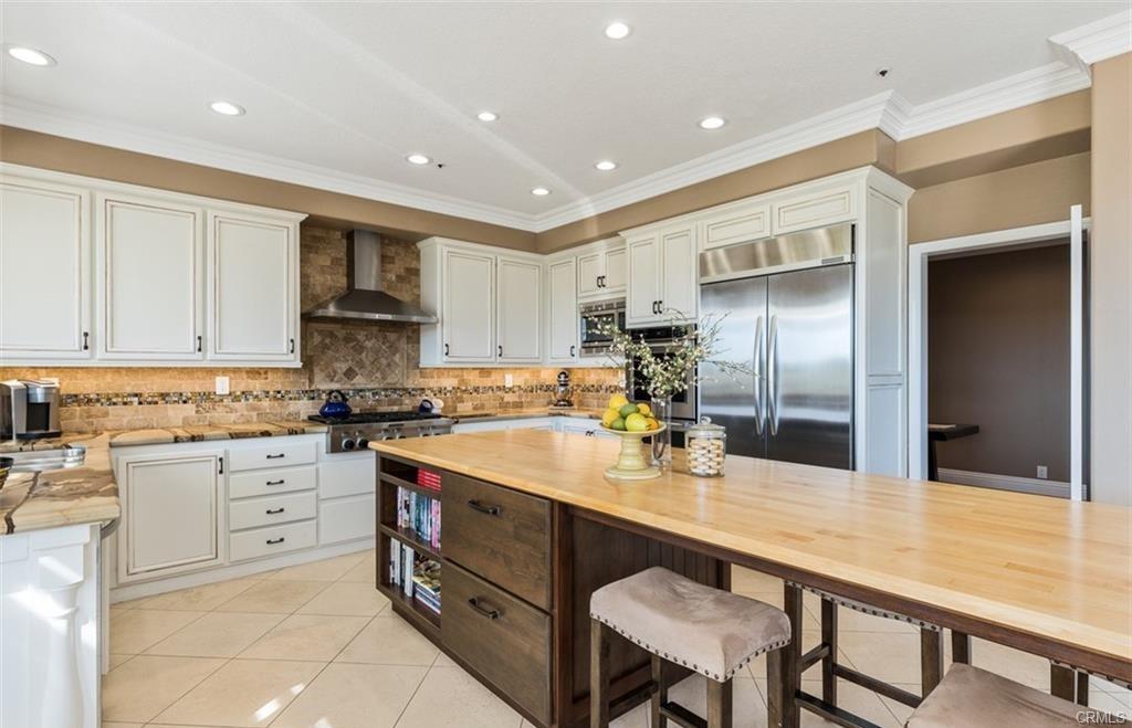 14 Dover — kitchen with expansive wood-topped island seating