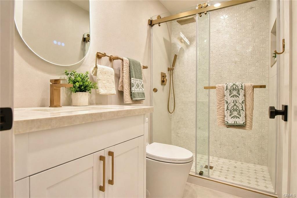 9142 Parliament Ave — designer-tiled bathroom with vanity and glass walk-in shower