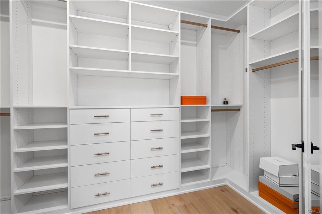 142 Sabbia — professionally designed primary walk-in closet