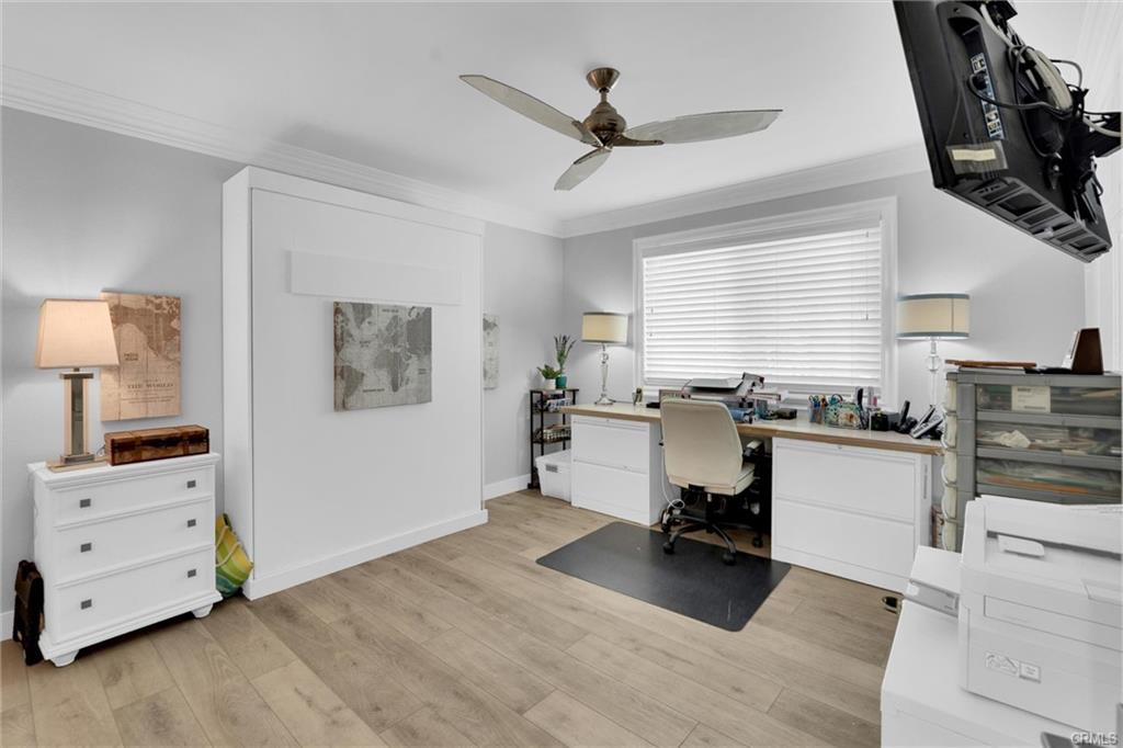 16276 Pacific Cir #B — bedroom suite with ceiling fan and natural light