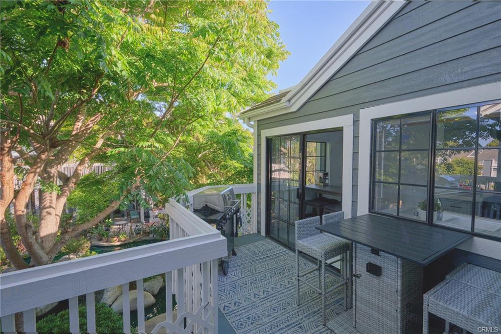 8132 Atwater Cir #202 — walkway and windows along the upper-level unit