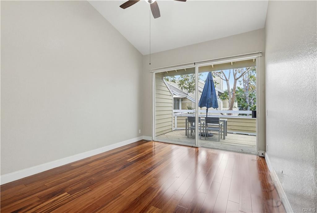 3650 S Bear St #77 — bedroom with vaulted ceiling and slider to the balcony