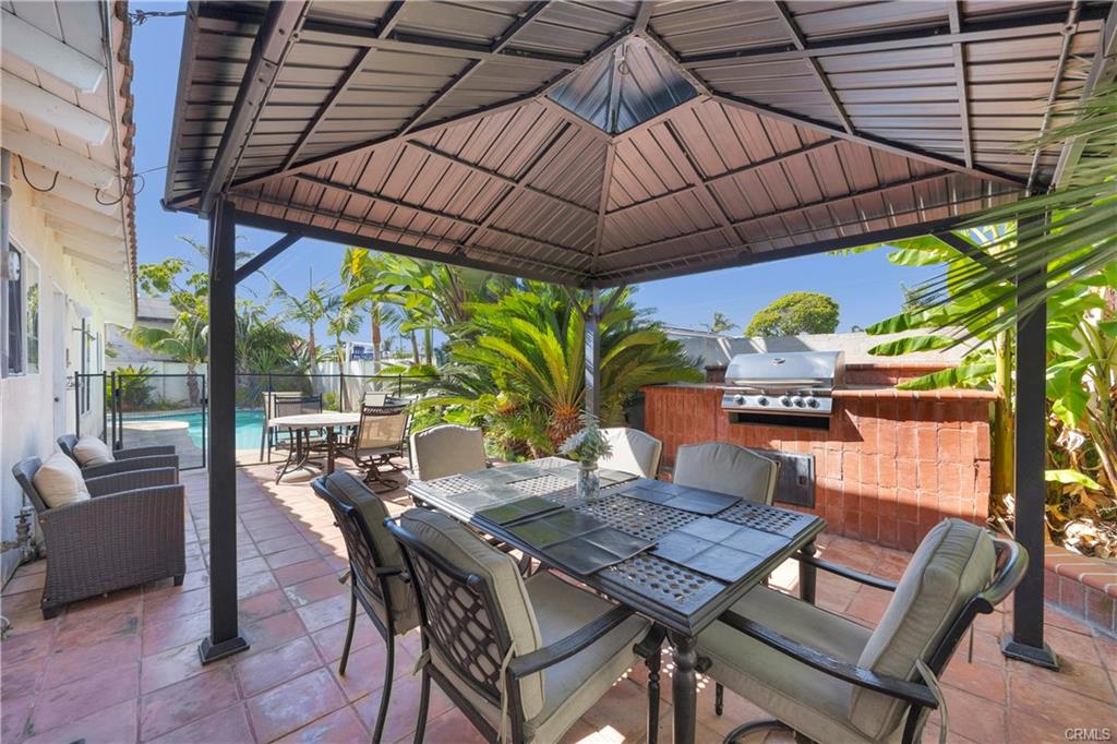 9112 Playa Dr — covered patio with dining and custom brickwork