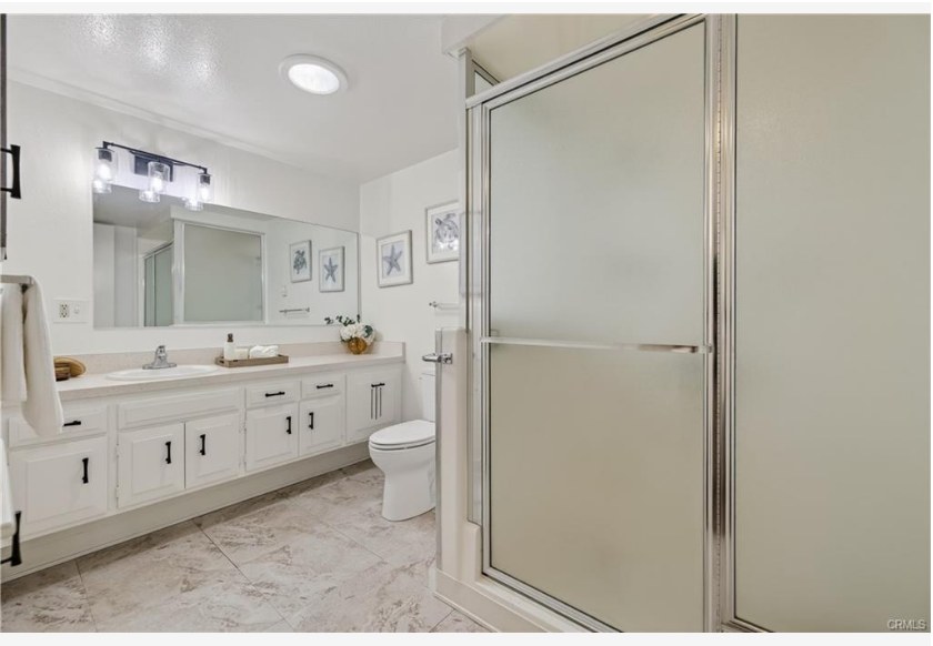 1200 Canoe Brook Dr #19D — bathroom with glass shower enclosure, vanity, and modern lighting