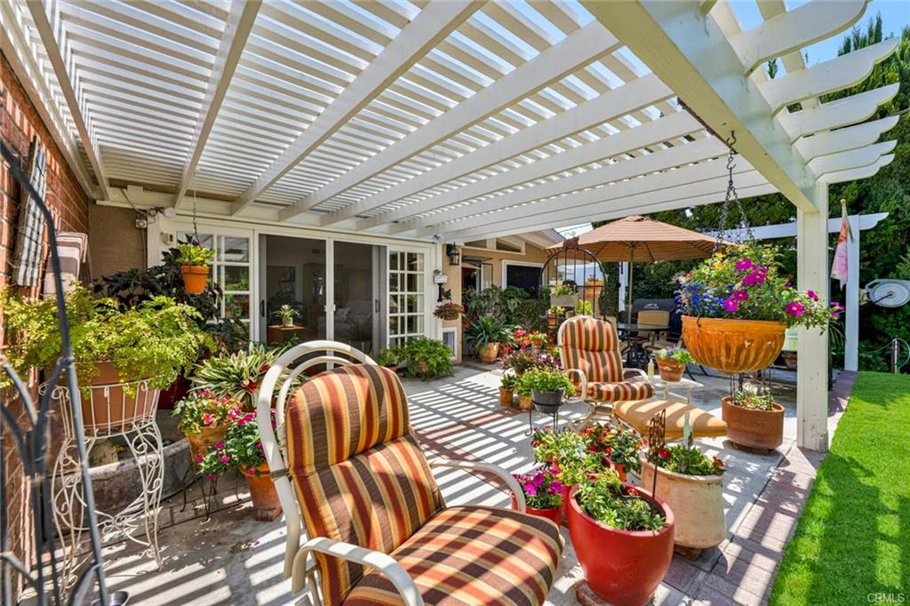 12231 Wilken Way — covered patio and pergola overlooking the garden
