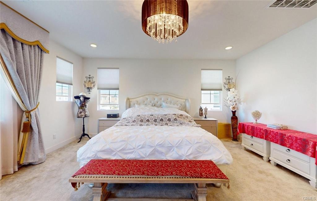 12954 Dahlia St — primary suite retreat with carpet and large windows