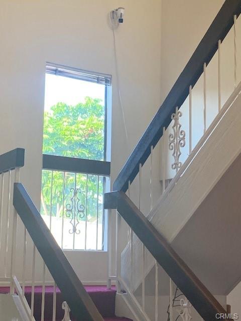 17031 Ward St — upstairs landing with railing and natural light