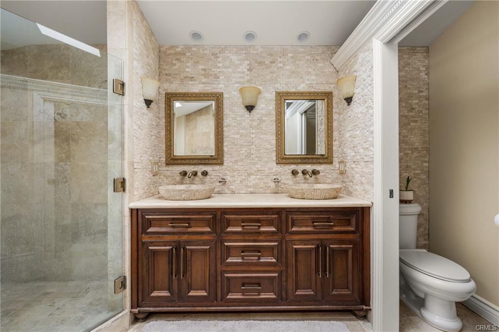 2342 Cynthia Ct — primary bath dual vanities with custom wood cabinetry