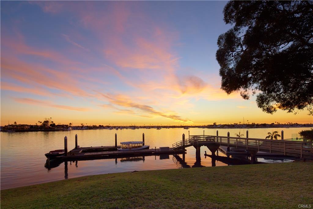 20 Harbor Island — sunset over the private dock and Newport Harbor turning basin