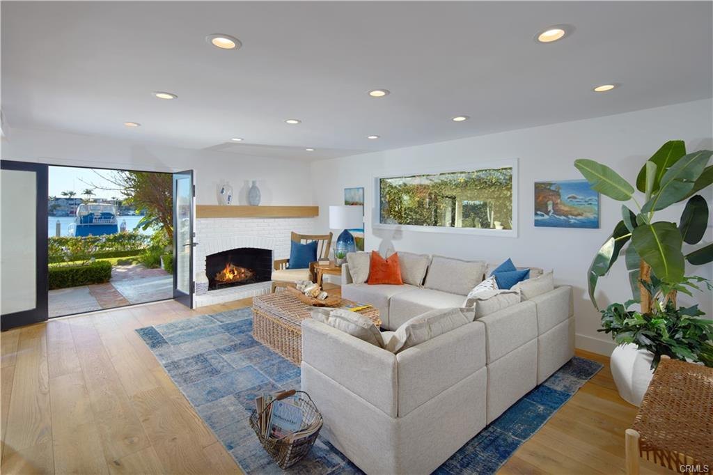 2572 Bayshore Dr — family room with fireplace opening to the water